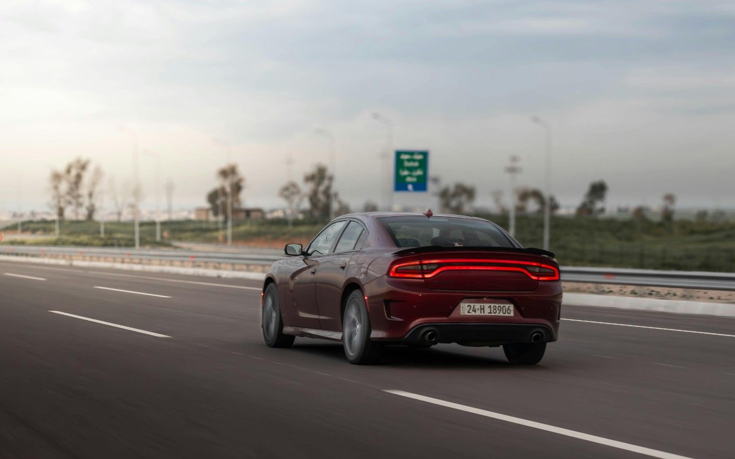 A modern silver sedan driving on a clean highway under a bright blue sky representing freedom and security